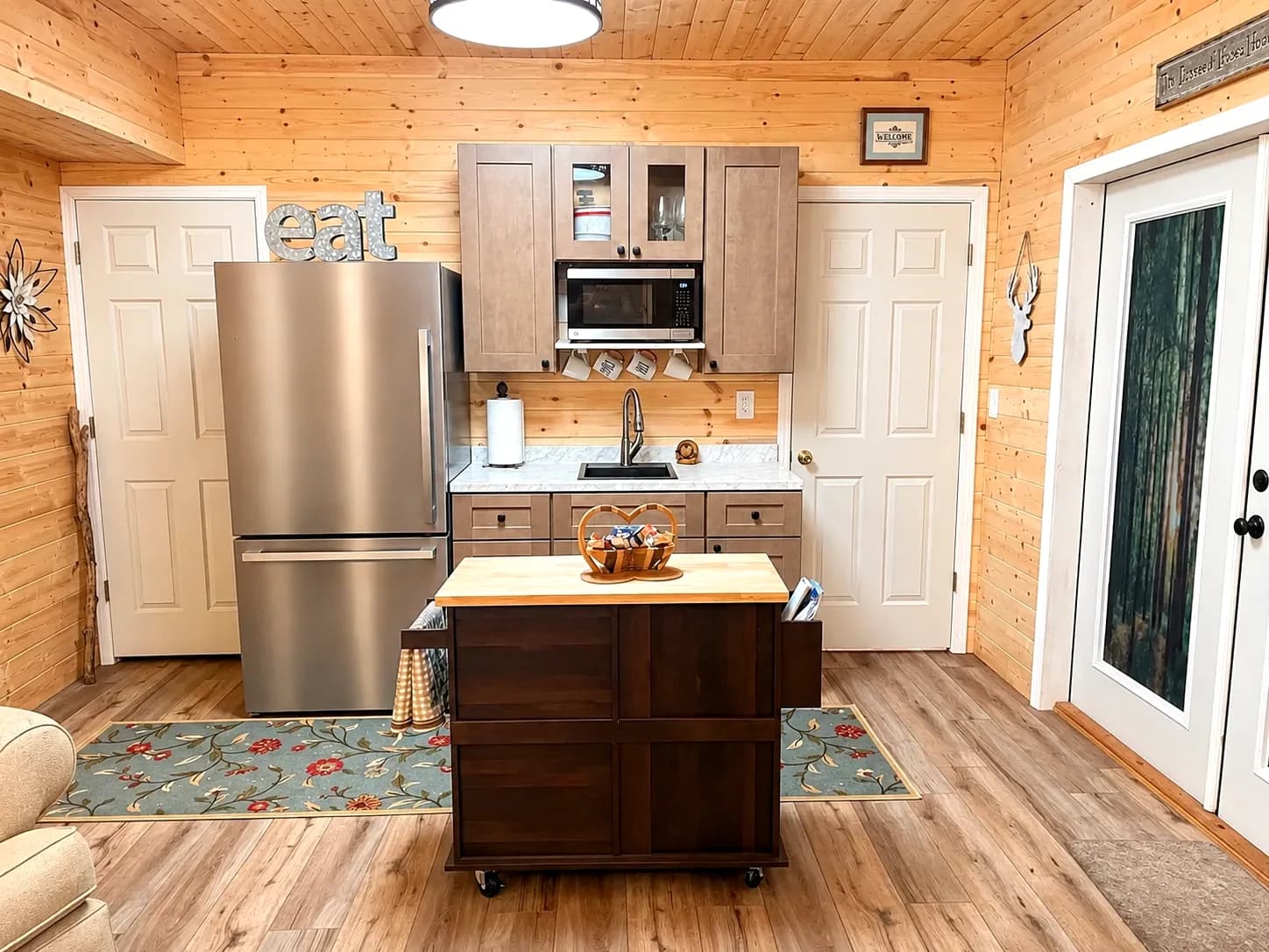 Kitchen with island, fridge, and forest-glass doors