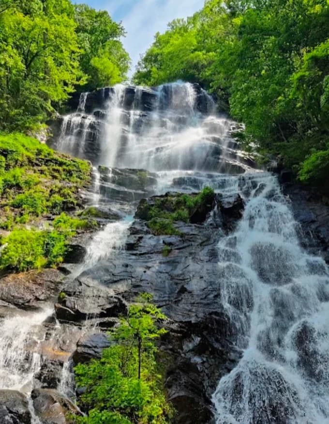 Amicalola Falls cascading over rock ledges surrounded by green trees